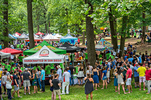 People taste samples of beer underneath a canopy of shady trees during the East Atlanta Beer Fest at Brownwood Park on Saturday, May 16, 2015. 