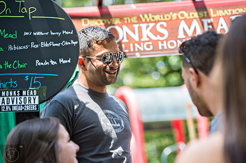Srikanth Vourganti (left) talks to people as he pours mead during the East Atlanta Beer Fest at Brownwood Park on Saturday, May 16, 2015. 