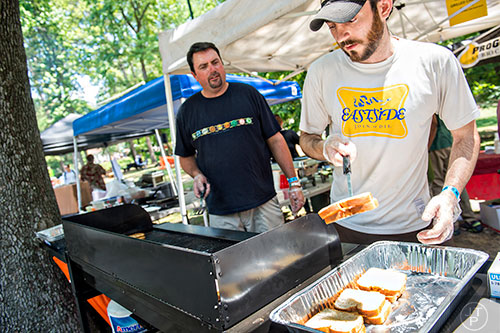 Kevin DeMarco (right) and Michael Wilson cook grilled cheese sandwiches during the East Atlanta Beer Fest at Brownwood Park on Saturday, May 16, 2015. 