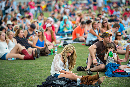Anna Claire Brett (center) listens to Cracker perform during the Shaky Boots Music Festival at Kennesaw State University on Sunday, May 17, 2015. 