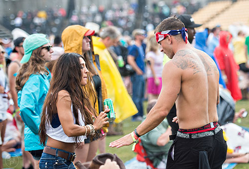 Yvette Sanz (left) dances with Jordan Brookshire as the Eli Young Band performs during the Shaky Boots Music Festival at Kennesaw State University on Sunday, May 17, 2015. 