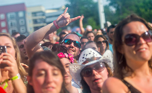 Nathan Keaton (center) watches Rodney Atkins perform during the Shaky Boots Music Festival at Kennesaw State University on Sunday, May 17, 2015. 