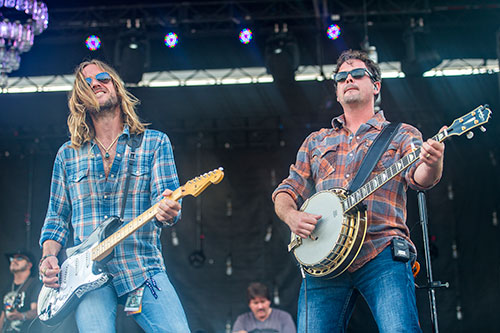 Phil Shouse (left) and Liam Bailey perform with Rodney Atkins during the Shaky Boots Music Festival at Kennesaw State University on Sunday, May 17, 2015. 