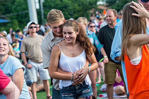 Jonathan Jenkins (center) dances with Tricia Knox as Rodney Atkins performs during the Shaky Boots Music Festival at Kennesaw State University on Sunday, May 17, 2015. 