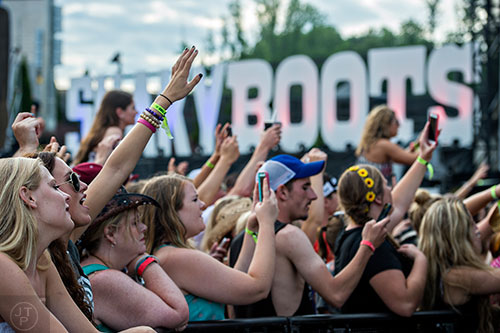 Gabby Burns (left) and Holly Stroman watch Justin Moore perform during the Shaky Boots Music Festival at Kennesaw State University on Sunday, May 17, 2015. 