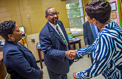 Dr. Stephen Green (center), the new superintendent for Dekalb County schools, shakes hands with Dr. Tracey Allen (right) as he meets principal Dr. Audrey Brooks' staff before touring Hambrick Elementary School in Stone Mountain on Wednesday, May 20, 2015. 