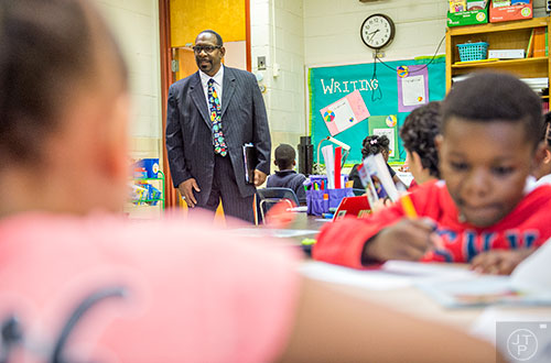 Dr. Stephen Green (center), the new superintendent for Dekalb County schools, watches students work in a classroom as he tours Hambrick Elementary School in Stone Mountain on Wednesday, May 20, 2015. 