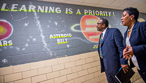 Dr. Stephen Green (left), the new superintendent for Dekalb County schools, walks past a mural with Hambrick Elementary School principal Dr. Audrey Brooks as he tours the school in Stone Mountain on Wednesday, May 20, 2015. 