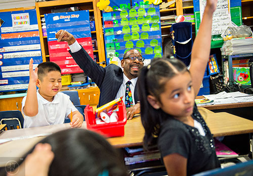Dr. Stephen Green (center), the new superintendent for Dekalb County schools, points out Alexander Nguyen to answer a question while touring Hambrick Elementary School in Stone Mountain on Wednesday, May 20, 2015. 
