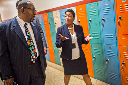 Dr. Stephen Green (left), the new superintendent for Dekalb County schools, walks past a row of lockers as he talks with Hambrick Elementary School principal Dr. Audrey Brooks while touring the school in Stone Mountain on Wednesday, May 20, 2015. 