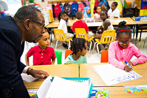 Dr. Stephen Green (left), the new superintendent for Dekalb County schools, talks with students as the do classwork while he tours Hambrick Elementary School in Stone Mountain on Wednesday, May 20, 2015.