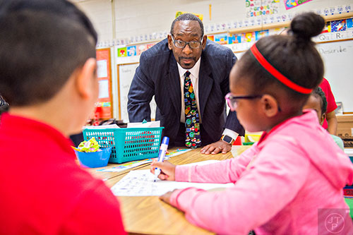 Dr. Stephen Green (center), the new superintendent for Dekalb County schools, watches students work on story problems while touring Hambrick Elementary School in Stone Mountain on Wednesday, May 20, 2015. 