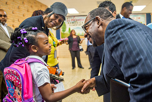 Dr. Stephen Green (right), the new superintendent for Dekalb County schools, shakes hands with Diamond Lewis as he talks with her and her mother Rita Hughey while touring Hambrick Elementary School in Stone Mountain on Wednesday, May 20, 2015. 