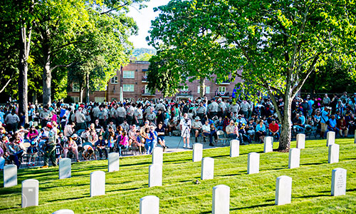 Hundreds of Boy Scouts, Girl Scouts and Cub Scouts gather at the Marietta National Cemetery to place flags on the 18,500 soldiers' grave stones in preparation for the Memorial Day service on Monday.   