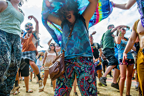 Britni Ulam (center) pops up from underneath a tie dyed sheet during the CounterPoint Festival at Kingston Downs in Rome on Sunday, May 24, 2015.