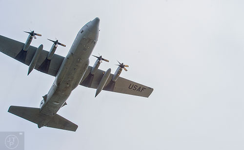 A C-130 airplane makes a pass over before the start of the annual Dacula Memorial Day Parade on Monday, May 25, 2015. 