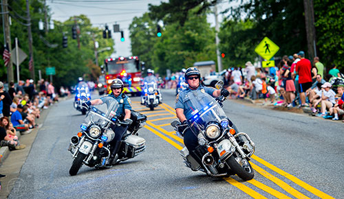Officers of Gwinnett County Police's special operations unit ride their motorcycles down Dacula Rd. during the annual Dacula Memorial Day Parade on Monday, May 25, 2015. 