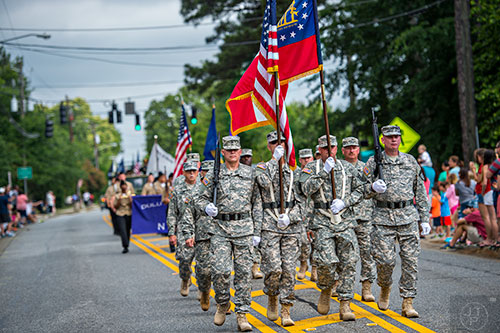 A color guard leads the annual Dacula Memorial Day Parade down Dacula Rd. on Monday, May 25, 2015. 