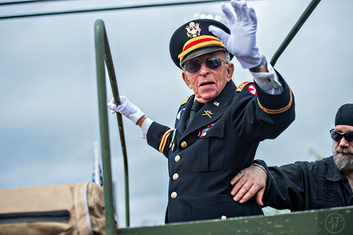 Grand Marshall Charles G. Mitchell, a WWII and Korean War veteran, waves to the crowd during the annual Dacula Memorial Day Parade on Monday, May 25, 2015. 