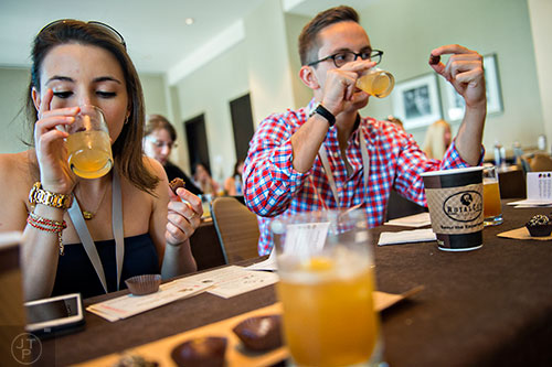 Emma Blumstein (left) and Mark Gockowski try a sampling of cocktails and chocolates during the Atlanta Food & Wine Festival at Loews Atlanta Hotel in Midtown on Saturday, May 30, 2015. 