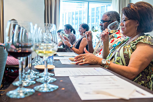 Avarita Hanson (right) and William Alexander sniff their first wine sample during the Atlanta Food & Wine Festival at Loews Atlanta Hotel in Midtown on Saturday, May 30, 2015. 