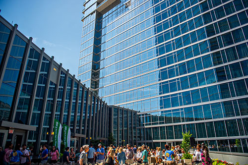 A crowd of people enjoy the sunshine outside on the balcony in between sessions during the Atlanta Food &; Wine Festival at Loews Atlanta Hotel in Midtown on Saturday, May 30, 2015. 