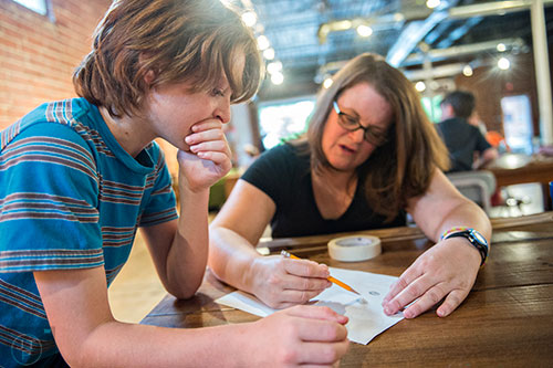 Camden Hyde (left) and his mother Jennifer plan out their bamboo lantern during a workshop at Color Wheel Studio in Decatur on Friday, April 24, 2015. 