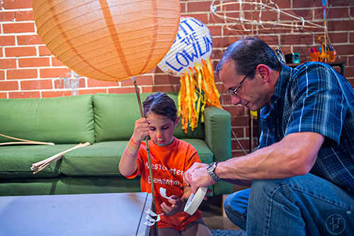 Silvia Malerba (left) and her father Rich decorate their lantern during a workshop at Color Wheel Studio in Decatur on Friday, April 24, 2015. 