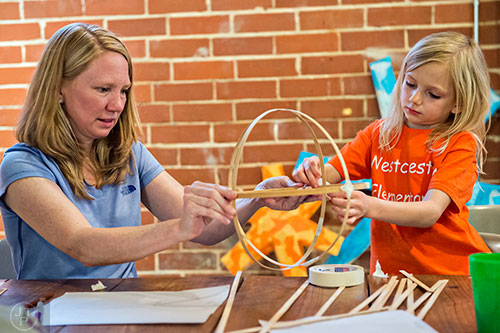 Keri Powell (left) helps her daughter Natalie Marks with her bamboo lantern during a workshop at Color Wheel Studio in Decatur on Friday, April 24, 2015. 