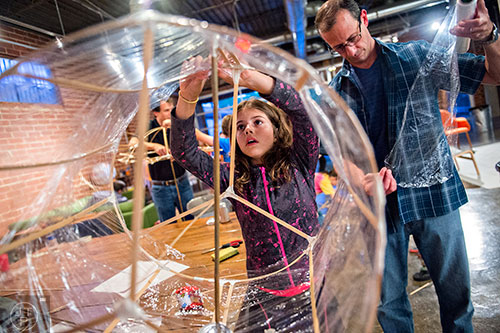 Gabriella Malerba (left) and her father Rich wrap their bamboo lantern during a workshop at Color Wheel Studio in Decatur on Friday, April 24, 2015. 