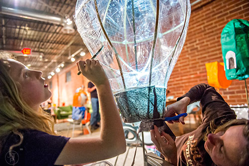 Lily Mae Barcik (left) and her mother Tiffany create a balloon shaped lantern during a workshop at Color Wheel Studio in Decatur on Friday, April 24, 2015. 