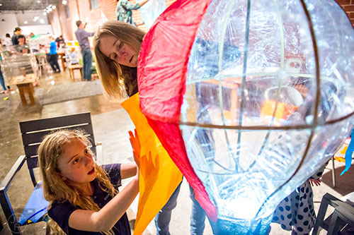 Lily Mae Barcik (left) and her mother Tiffany create a balloon shaped lantern during a workshop at Color Wheel Studio in Decatur on Friday, April 24, 2015. 