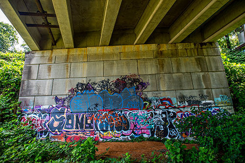 Graffiti marks walls of a bridge along a section of yet to be developed Atlanta Beltline Trail on Friday, May 29, 2015.