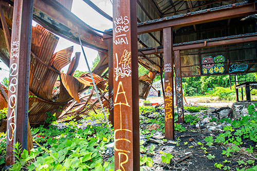 Graffiti marks the walls and steel beams in an abandoned and dilapidated building near a section of yet to be developed Atlanta Beltline Trail on Friday, May 29, 2015.