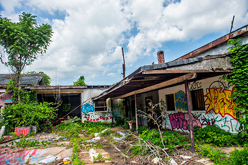 Graffiti marks walls of a group of abandoned garages near a section of yet to be developed Atlanta Beltline Trail on Friday, May 29, 2015.