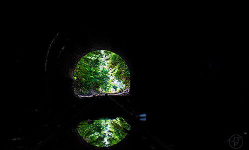 Train tracks run through a tunnel on a section of yet to be developed Atlanta Beltline Trail on Friday, May 29, 2015.