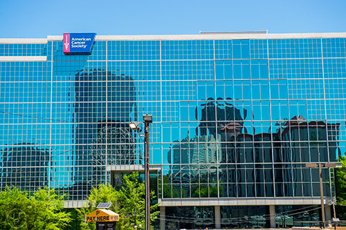 Some of the buildings in downtown Atlanta are reflected in the mirrored windows of the American Cancer Society building on Wednesday, May 13, 2015.