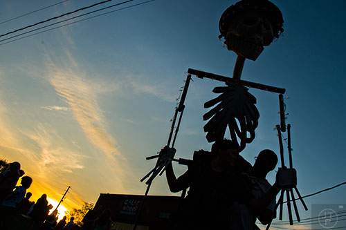 Tim Marker (right) helps his son Coleman with his skeleton lantern before the start of the Decatur Lantern Parade at Color Wheel Studio on Friday, May 15, 2015. 
