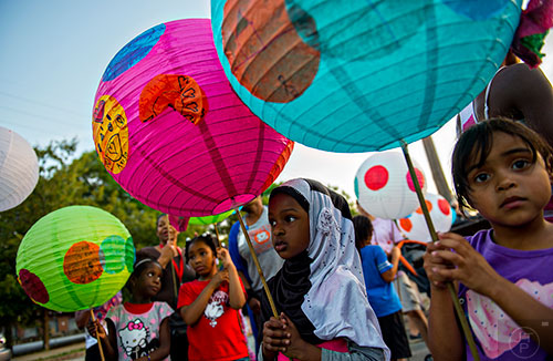 Nadiya Mohamed (right) and Anisa Sharif hold their lanterns as they wait for the start of the Decatur Lantern Parade on Friday, May 15, 2015.