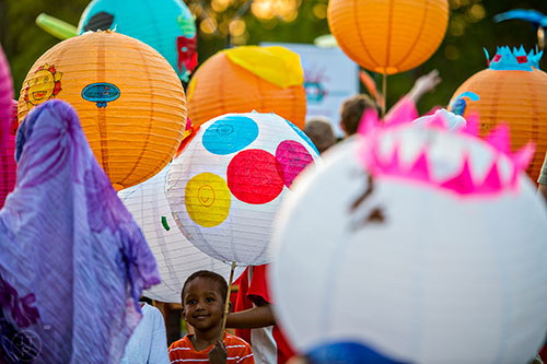 Ayub Sharif holds his lantern as he waits for the start of the Decatur Lantern Parade on Friday, May 15, 2015.