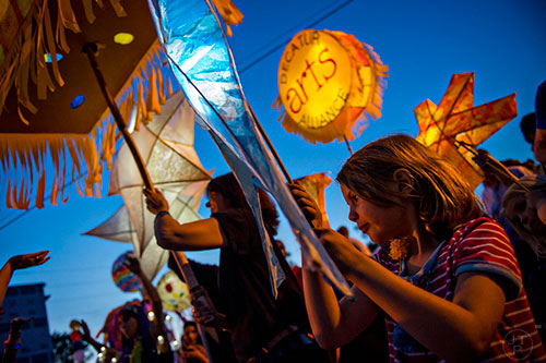 Eleanor Campbell (right) carries her star shaped lantern during the Decatur Lantern Parade on Friday, May 15, 2015.