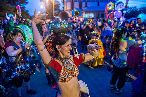 Ziah McKinney (center) belly dances during the Decatur Lantern Parade on Friday, May 15, 2015.