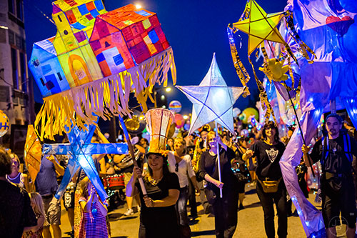 Chantelle Rytter (center left) leads the Decatur Lantern Parade down E. Howard Ave on Friday, May 15, 2015.  