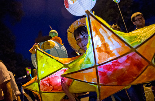 Luke Beckham carries star lanterns during the Decatur Lantern Parade on Friday, May 15, 2015.