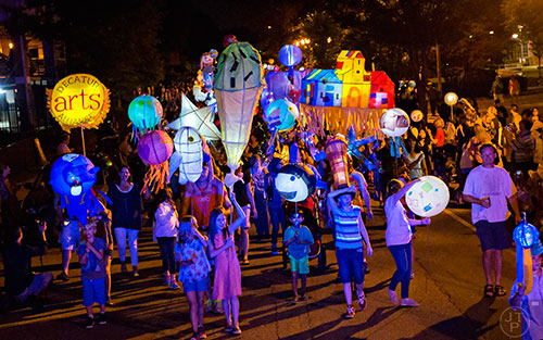 Lanterns fill the street as people march toward Decatur Square during the Decatur Lantern Parade on Friday, May 15, 2015.