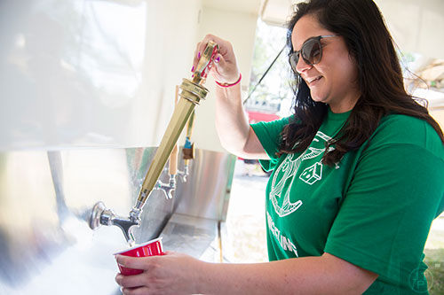 Brie Petrilli pours a beer during the Kirkwood Spring Fling at Bessie Branham Park on Saturday, May 16, 2015.