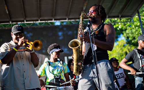 Kebbi Williams (right) performs with Wolfpack ATL during the Atlanta Jazz Fest at Piedmont Park on Saturday, May 23, 2015.