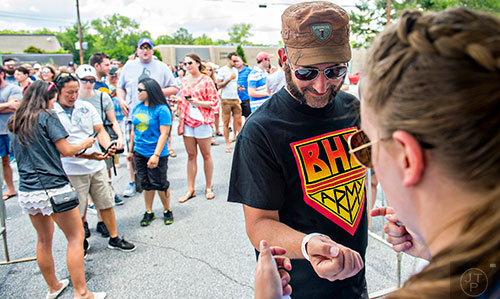 Todd Major gets his armband as he enters the Georgia Craft Beer Festival outside of Red Brick Brewing in Atlanta on Saturday, May 30, 2015. 