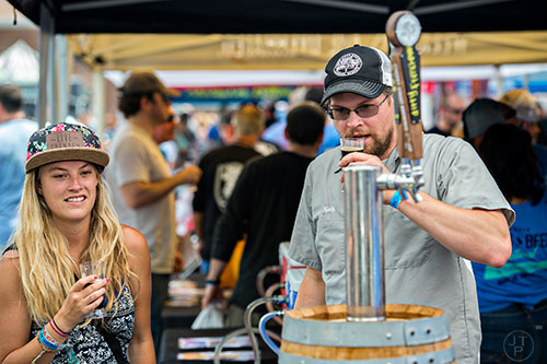 Ashford McIntyre (left) talks with Nick Tanner as they sample beer during the Georgia Craft Beer Festival outside of Red Brick Brewing in Atlanta on Saturday, May 30, 2015. 