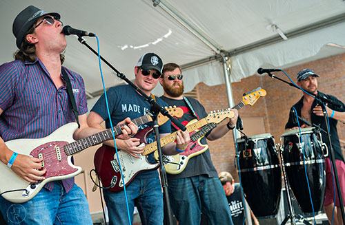 Tyler Cates (left) and other members of The Great Gig in the Rye perform on stage during the Georgia Craft Beer Festival outside of Red Brick Brewing in Atlanta on Saturday, May 30, 2015. 